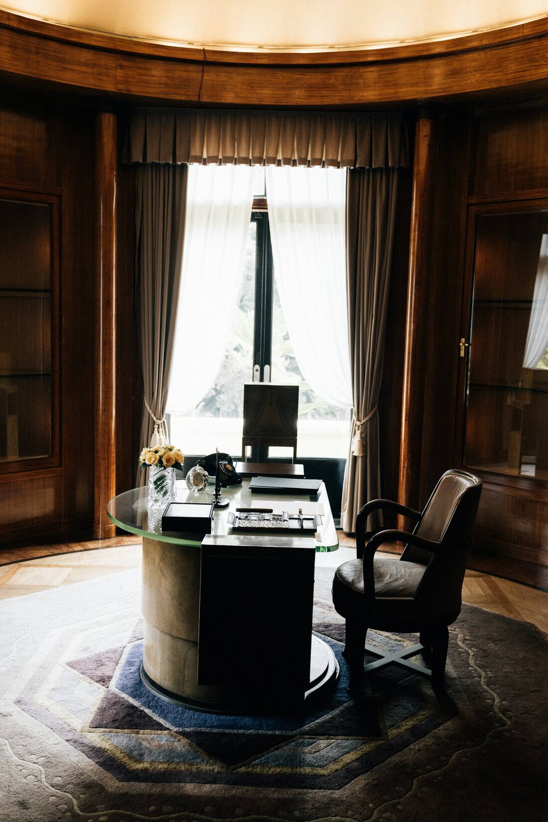 Physician’s private office with a desk by a tall window